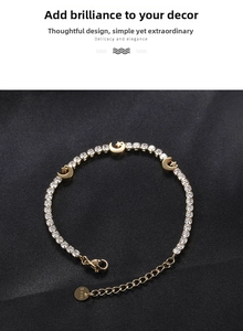 Detailed macro view of gold plated celestial bracelet with moon star charms and zircons