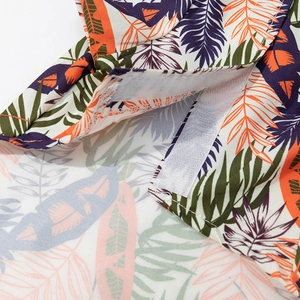 Hawaiian pet shirt with tropical leaf print and secure white hook-and-loop closure