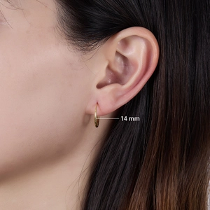 Close-up of 14mm gold geometric hoop earrings worn by a model for size visualization