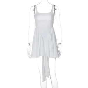 Detailed close-up of white summer dress featuring square neck and side drawstring accents