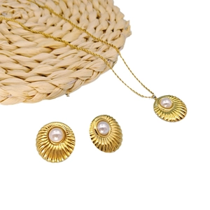 Golden vintage jewelry set featuring pearl shell texture pendant necklace and stud earrings