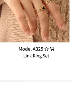 Detail of gold chain-style rings with black rectangular stone on a model's hand
