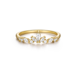 Macro shot of a golden crown-shaped ring featuring sparkling marquise-cut zircon stones