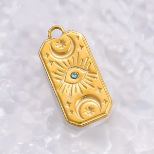 Detailed view of an 18K gold rectangle star pendant with a blue evil eye on ice crystals