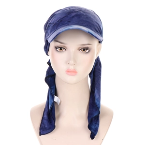 Detail of blue tie-dye headscarf hat with sun visor shown on a beige mannequin head