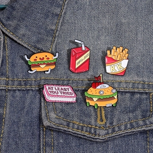 Funny food enamel pins set featuring a hamburger and fries on a blue denim jacket