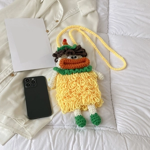 Handmade yellow knit crossbody bag featuring a cute sausage lip doll design with green shoes