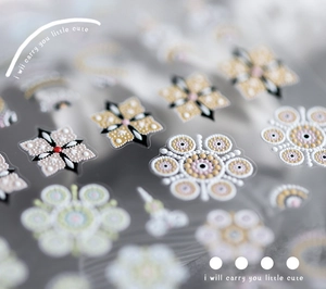 Dettaglio macro di adesivi per unghie 5D in rilievo con motivi mandala e fiori