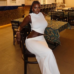 Slim fit two-piece white set with sleeveless crop top and long bodycon skirt for women