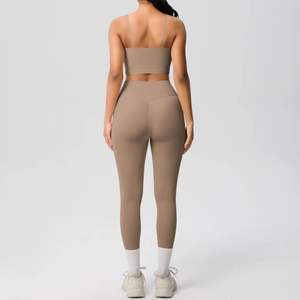 Detail of cross-back yoga top and high-waist leggings in earthy brown matte fabric