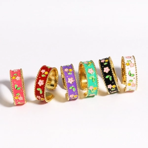 Detail of six adjustable open rings with colorful floral enamel and gold bead edging