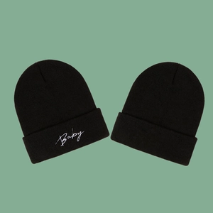 Classic black knit beanie hat with white Baby embroidery and ribbed cuff design