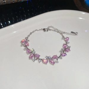 Close-up of pink marquise zircon stones set in silver metal chain with lobster clasp