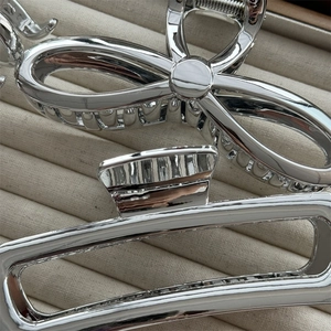 Sleek silver metal hair claw clips with bow and geometric hollow designs for women