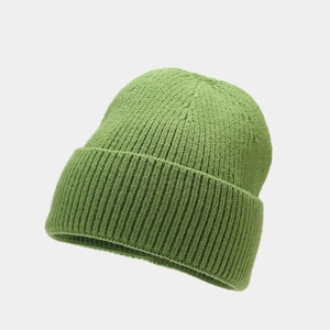 Close-up of grass green chunky knit beanie showing textured warm weave and cuff detail