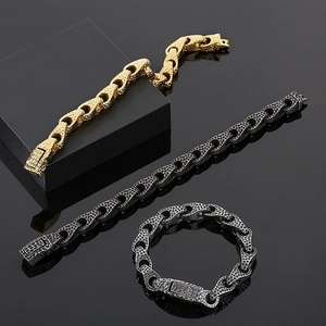Macro shot of 18k gold and gunmetal hammered texture bracelets on a black background