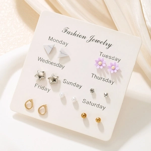 Detail view of 7-pair stud earring set on cards featuring floral and geometric designs
