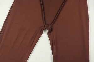 Detailed close-up of dark brown ruched fabric with tie-up knot detail on bodysuit