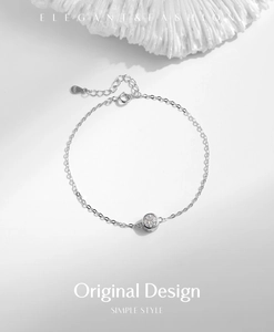 Close-up of S925 sterling silver bracelet featuring a round moissanite on a coral texture