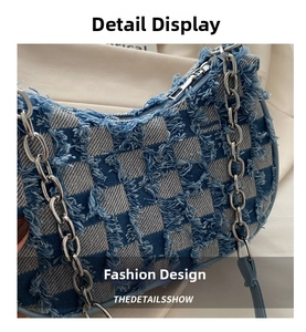 Detail view of denim checkerboard crescent bag featuring frayed edges and silver chain