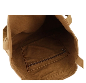 Internal view of the brown canvas tote bag showing the durable zippered inner pocket