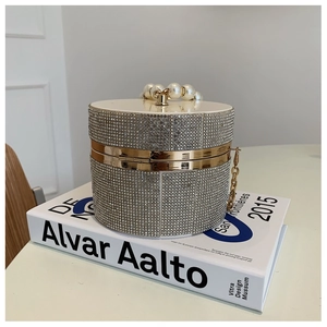 Close-up of sparkling rhinestone evening bag with pearl handle and golden clasp