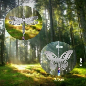 Macro view of metal butterfly and dragonfly suncatchers with crystal bead pendants