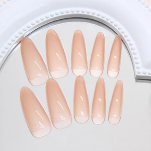 Almond-shaped nude pink press-on nails with classic white French tips on glossy finish