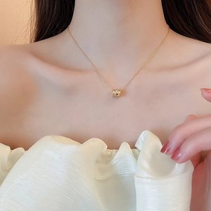 Detail of 18k gold plated flower lock necklace with sparkling crystal cylinder pendant