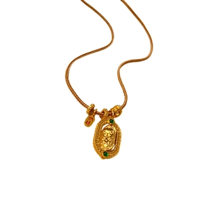 Gold plated oval pendant necklace with green gemstones and traditional Chinese motifs