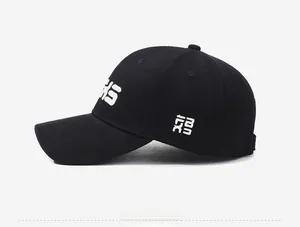 Side view of black baseball cap showing white embroidery and breathable cotton fabric
