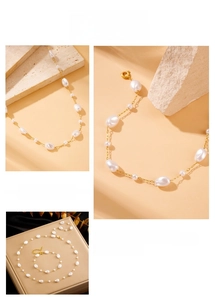 Detail of baroque pearl necklace and bracelet set with golden stainless steel chain links