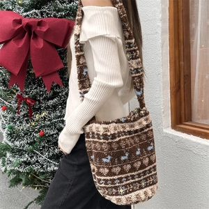 Close-up of plush jacquard bucket bag with soft fleece strap in winter outdoor setting