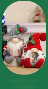 Detail of gray and red knitted Christmas gnomes with white beards on a cozy wood surface