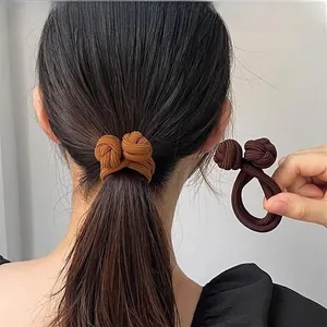 Close-up of elastic double-knot hair ties in ginger and coffee colors on a ponytail