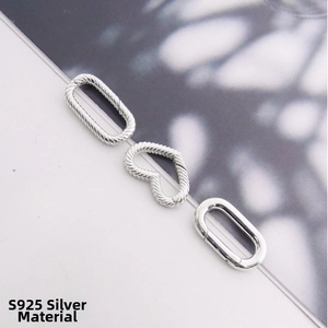 Macro view of S925 sterling silver heart and oval link connectors with spiral texture