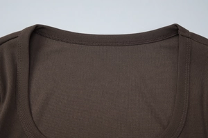 Nahaufnahme des U-Ausschnitts und der Rippstrick-Textur dieses braunen Crop-T-Shirts