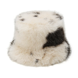 Close-up of soft cow print faux fur bucket hat with thick plush texture for winter warmth
