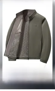 Detail of grey-green stand collar jacket with mesh texture and geometric print lining