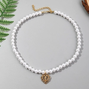Detail of multi-layer baroque pearl necklace with heart cross pendant and adjustable clasp