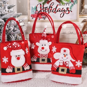 Three 3D knitted Christmas gift bags featuring Santa, Reindeer and Snowman designs