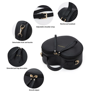Detail view of heart-shaped black Saffiano bag with golden hardware and adjustable strap