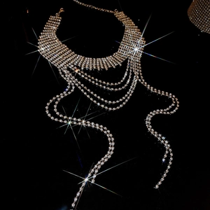Macro shot of silver multi-layer rhinestone choker with cascading long fringe tassels