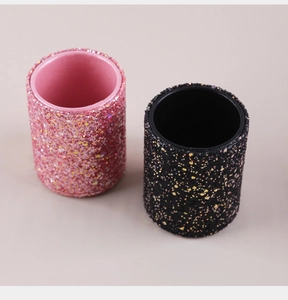Pink and black glitter makeup brush holders with sparkling textured surface for vanity