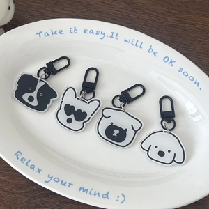 Cartoon dog acrylic keychains featuring border collie and pug on a white plate