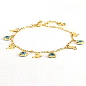 Detailed close-up of golden chain bracelet featuring evil eye beads and butterfly charms