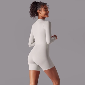 Detailed side view of light grey long sleeve athletic romper showing slim fit design