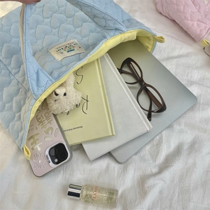 Spacious heart-quilted light blue tote bag showing its large interior capacity