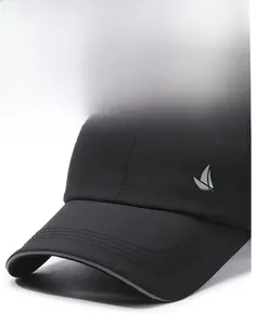 Close-up of black quick-dry sports cap with sailboat logo and reinforced brim stitching
