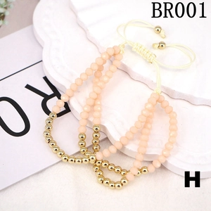 Close-up of three pink matte crystal bead bracelets with adjustable gold string closures